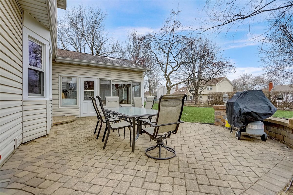 827 Manchester Street Naperville, IL 60563 - Photo 44 of 48 a view of a patio with table and chairs and potted plants