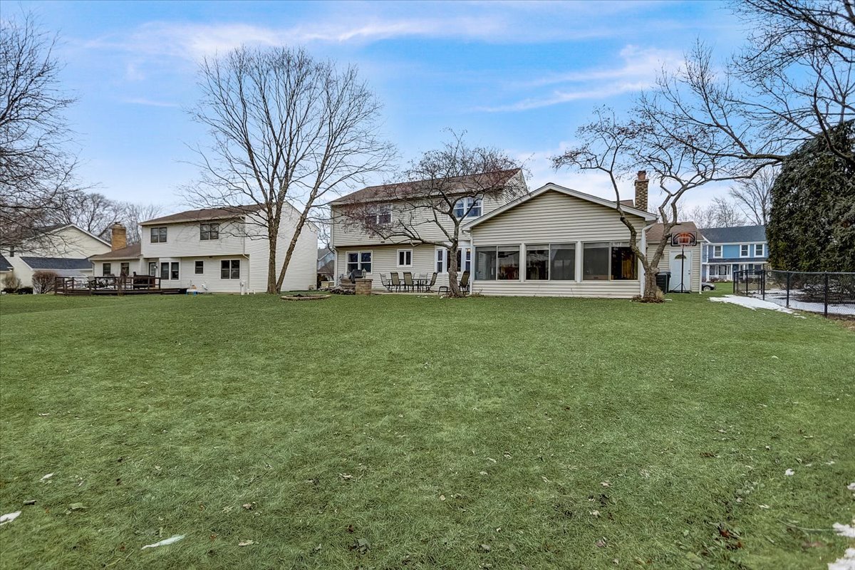 827 Manchester Street Naperville, IL 60563 - Photo 46 of 48 a view of a white house next to a yard with big trees