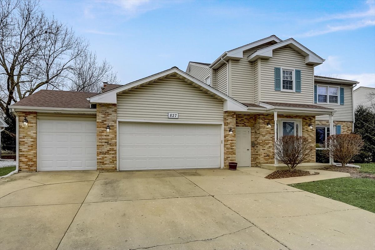 827 Manchester Street Naperville, IL 60563 - Photo 48 of 48 a front view of a house with a yard and garage