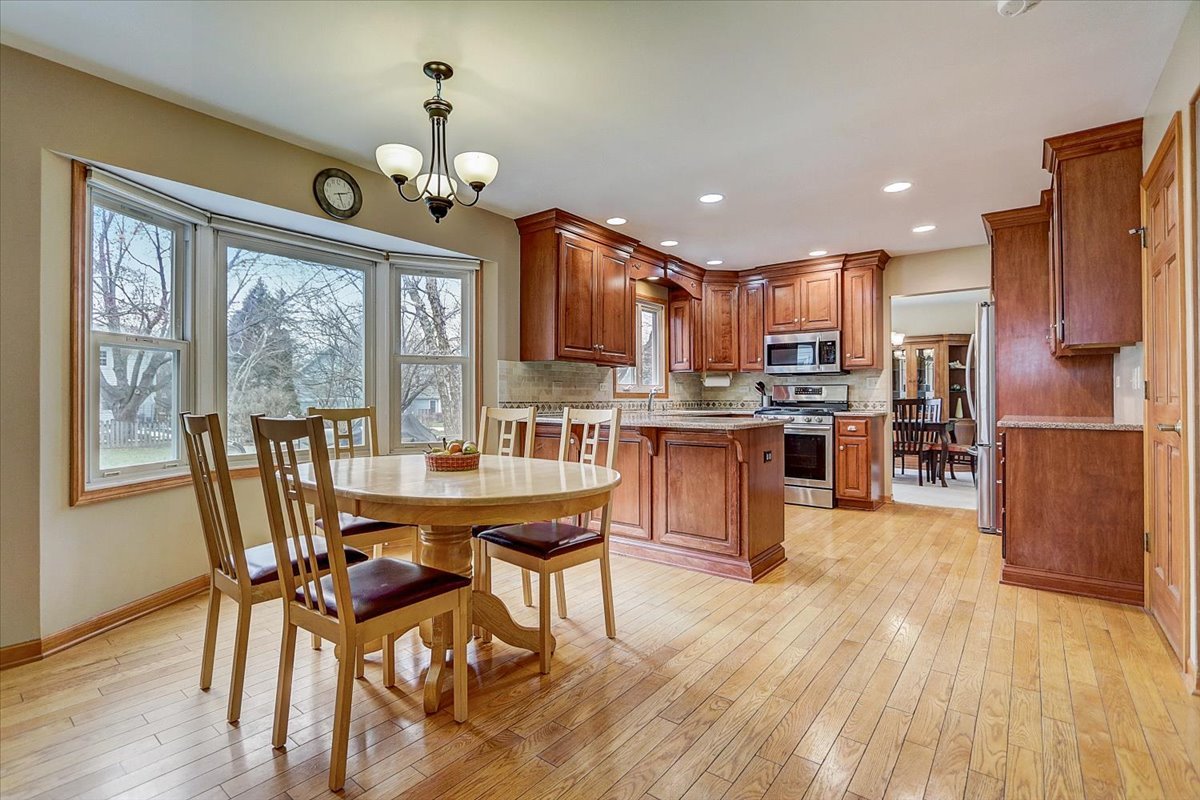 827 Manchester Street Naperville, IL 60563 - Photo 5 of 48 a view of a dining room with furniture window and wooden floor
