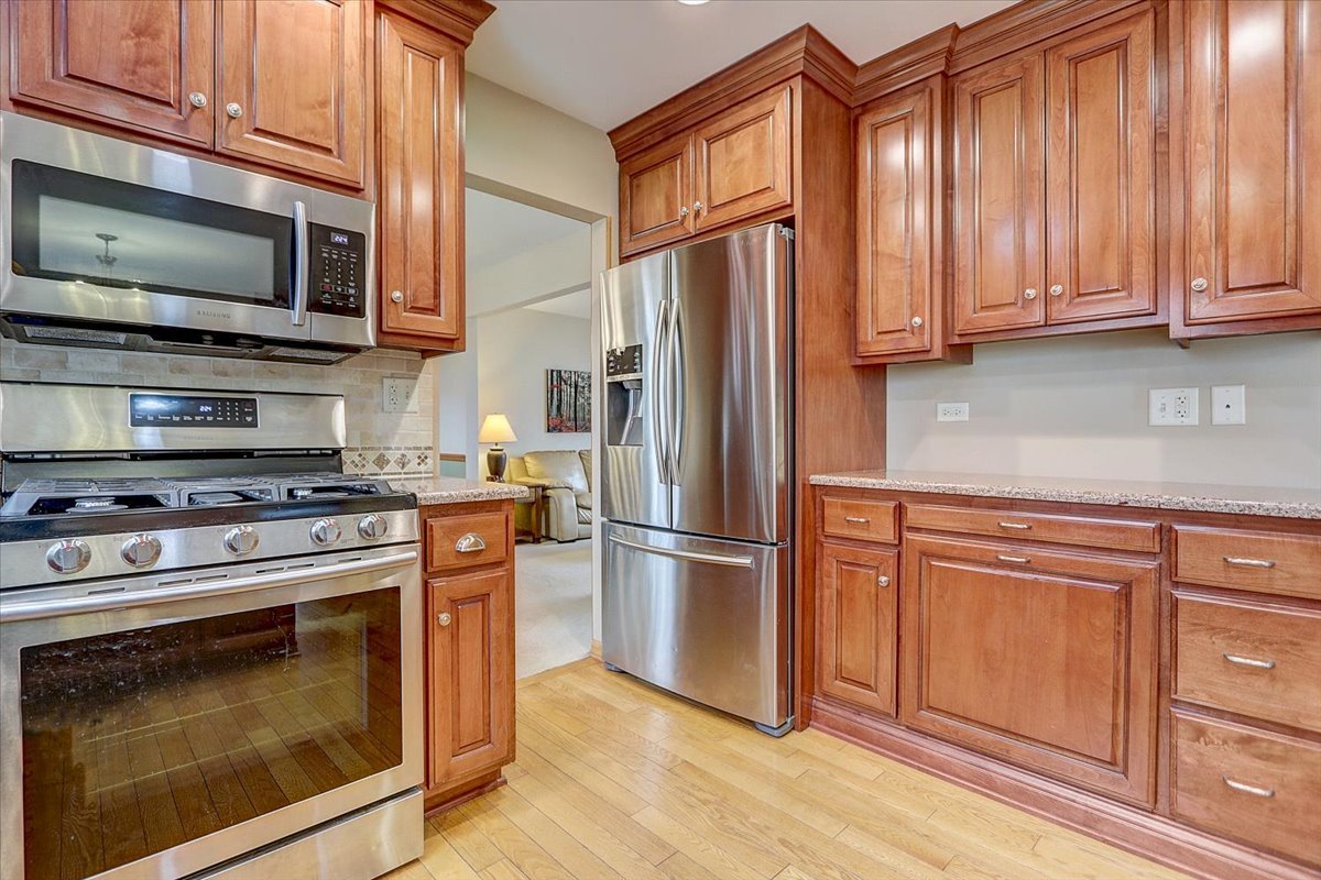 827 Manchester Street Naperville, IL 60563 - Photo 9 of 48 a kitchen with stainless steel appliances granite countertop a stove microwave refrigerator and cabinets