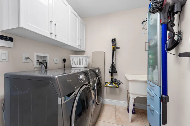 a view of a storage and utility room with washer and dryer