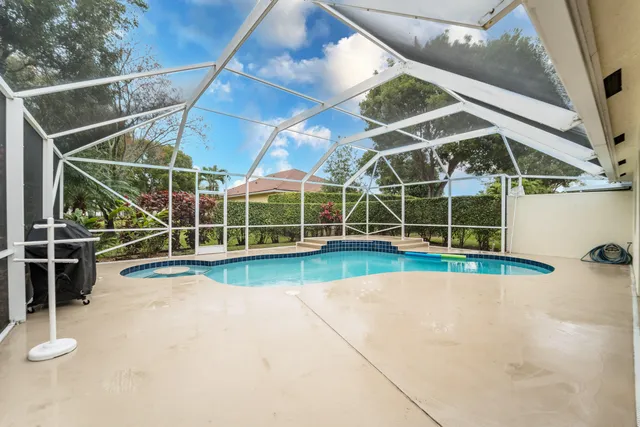 a view of a swimming pool with a yard in front of it