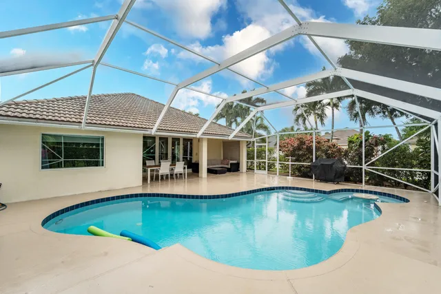 a view of a swimming pool with outdoor seating