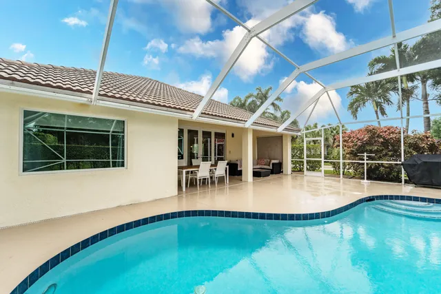 a view of a swimming pool with outdoor seating