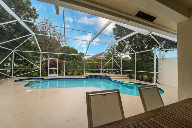 a view of a backyard with wooden floor and door