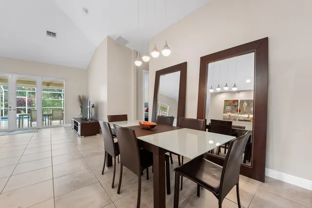 a view of a dining room with furniture large windows and wooden floor