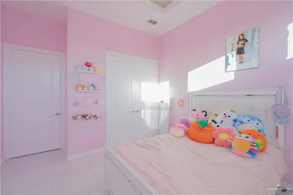 a bedroom with a bed and a tv
