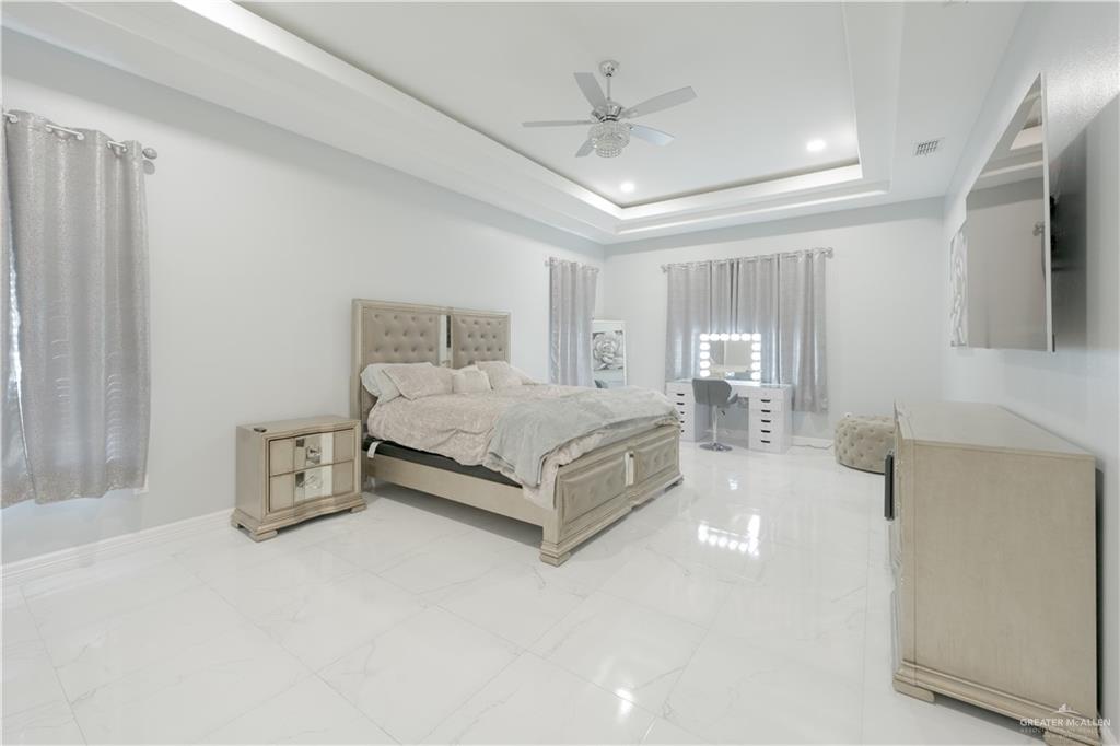 2511 Wisteria Street Rio Grande City, TX 78582 - Photo 11 of 27 a spacious bedroom with a bed and a flat tv screen