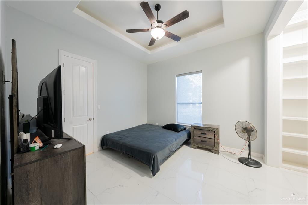2511 Wisteria Street Rio Grande City, TX 78582 - Photo 14 of 27 a bedroom with a bed and a flat tv screen on the wall