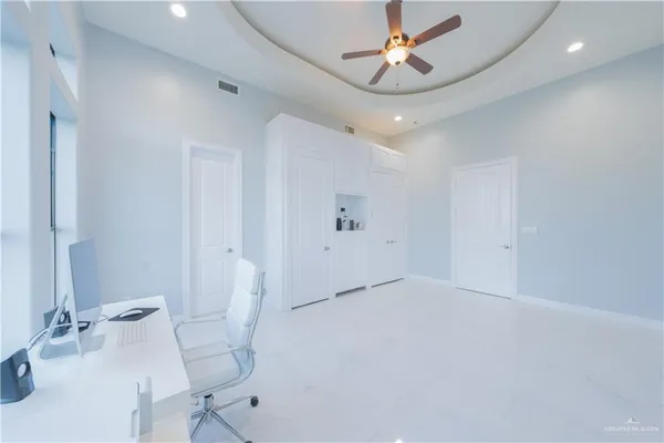 a bedroom with a bed and a flat tv screen on the wall