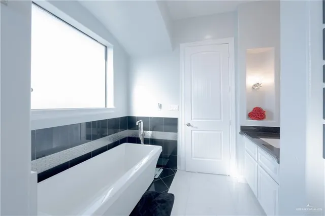 a bathroom with a double vanity sink and a mirror