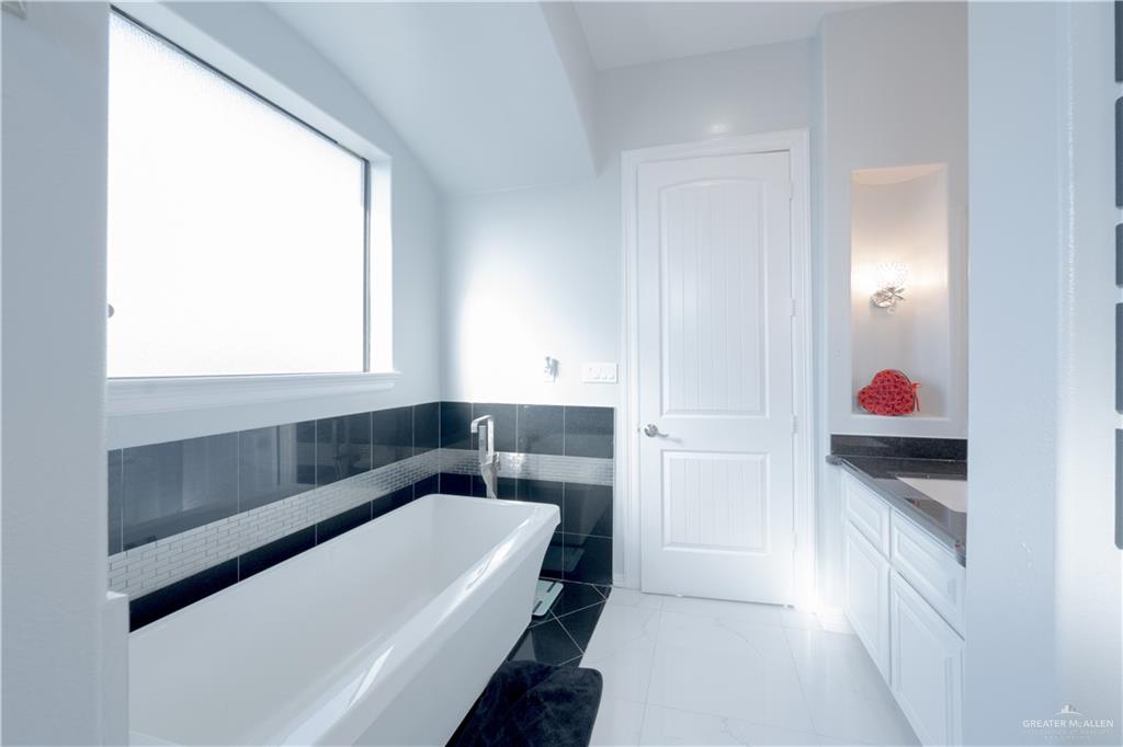 2511 Wisteria Street Rio Grande City, TX 78582 - Photo 19 of 27 a bathroom with a bathtub and a window