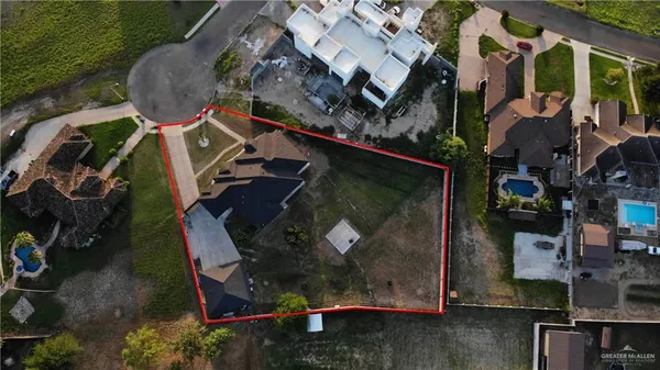 a kitchen with a refrigerator and white cabinets