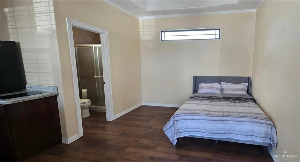 2511 Wisteria Street Rio Grande City, TX 78582 - Photo 26 of 27 a bedroom with a bed and wooden floor