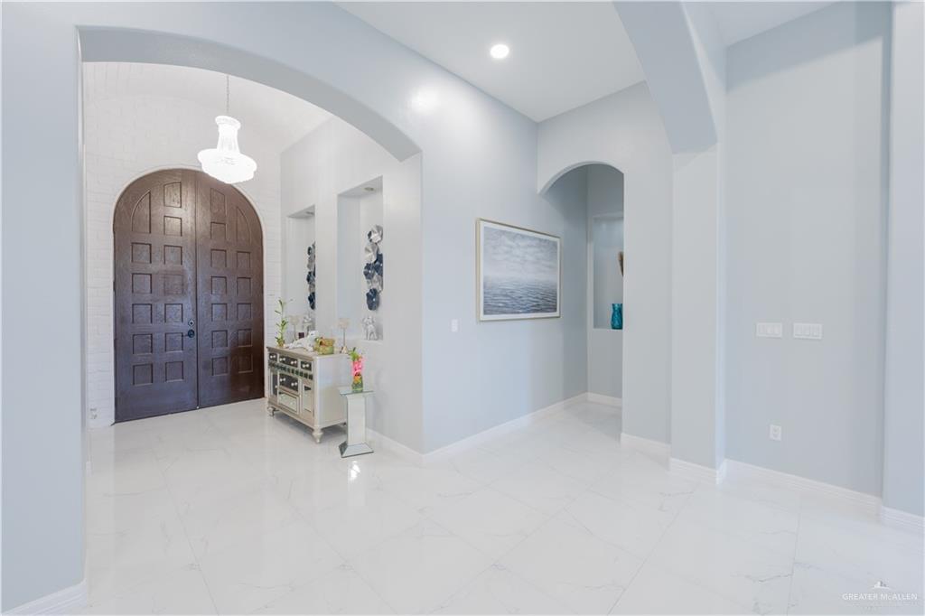 2511 Wisteria Street Rio Grande City, TX 78582 - Photo 3 of 27 wooden floor in an empty room with a mirror