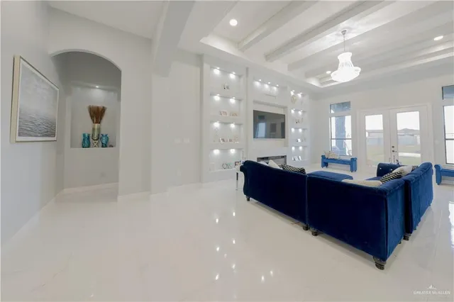a living room with stainless steel appliances kitchen island granite countertop furniture and a large window