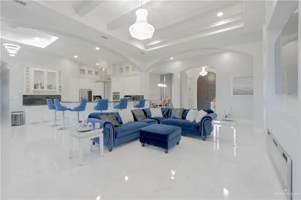 a living room with lots of furniture and a chandelier