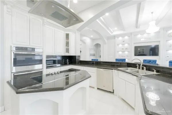 a kitchen with stainless steel appliances granite countertop a sink and a stove