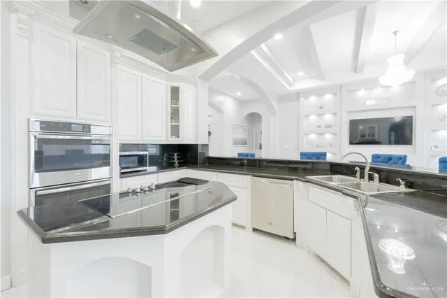 a kitchen with stainless steel appliances granite countertop a sink and a stove