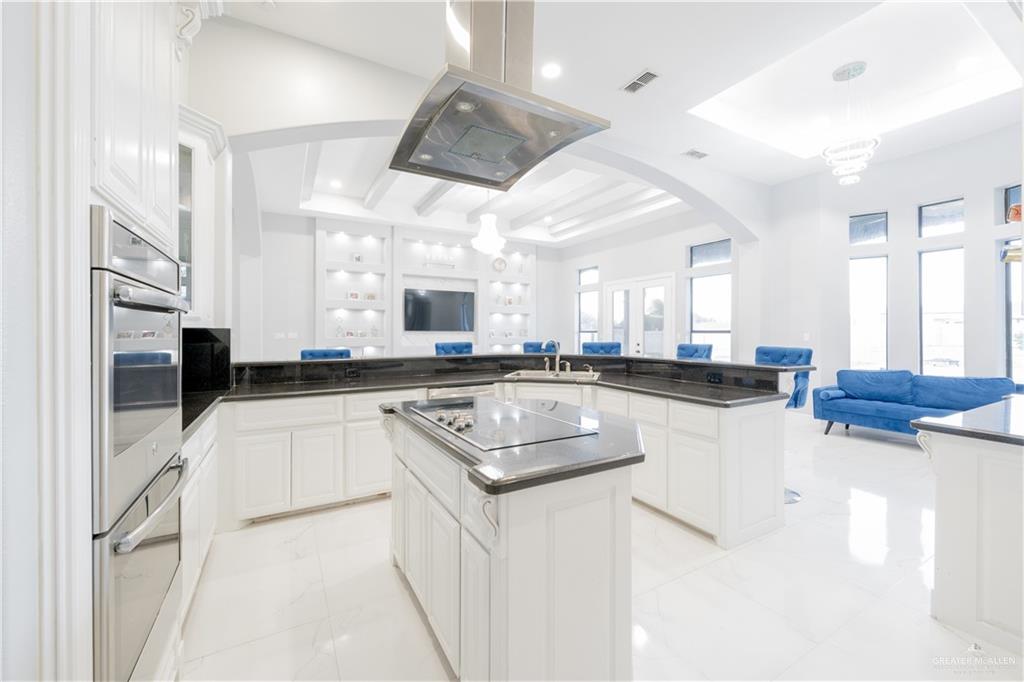 2511 Wisteria Street Rio Grande City, TX 78582 - Photo 27 of 27 a kitchen with stainless steel appliances granite countertop a sink a stove and a refrigerator
