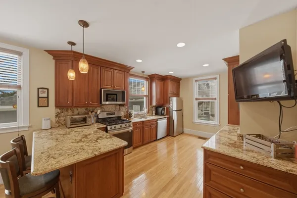 a kitchen with sink stove microwave and refrigerator
