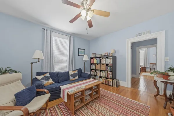 a living room with furniture and a book shelf
