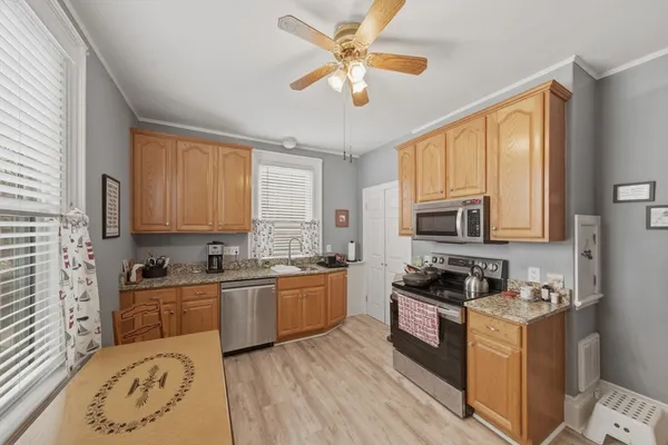 a kitchen with stainless steel appliances granite countertop a stove a sink and a refrigerator