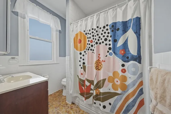 a bathroom with a sink and mirror with toilet