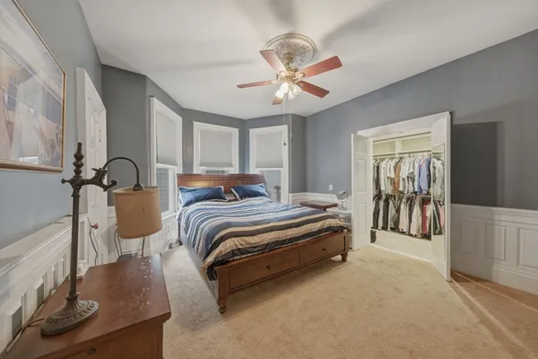 a bedroom with a bed and ceiling fan