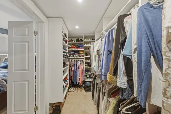 a view of walk in closet with clothes
