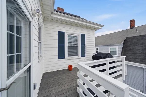 a view of house with wooden deck and a ocean