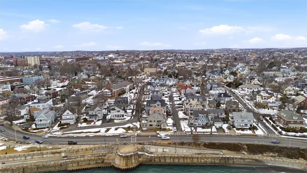 an aerial view of residential building with green space
