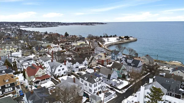 an aerial view of a house with a lake view
