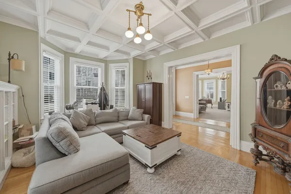 a living room with furniture a flat screen tv and a large window
