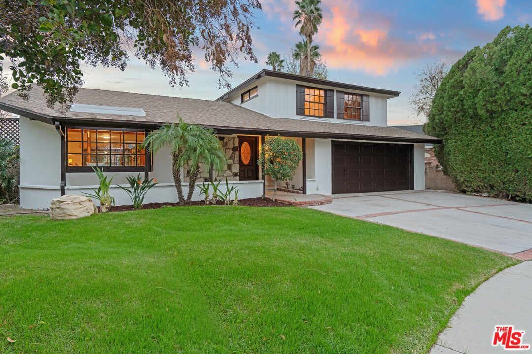 20650 Stagg Street Winnetka, CA 91306 - Photo 1 of 42 a front view of a house with garden
