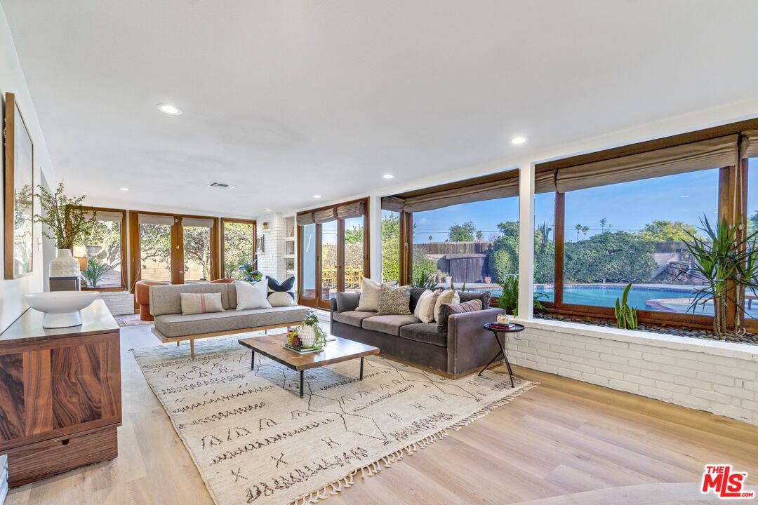 20650 Stagg Street Winnetka, CA 91306 - Photo 11 of 42 a living room with furniture and a large window