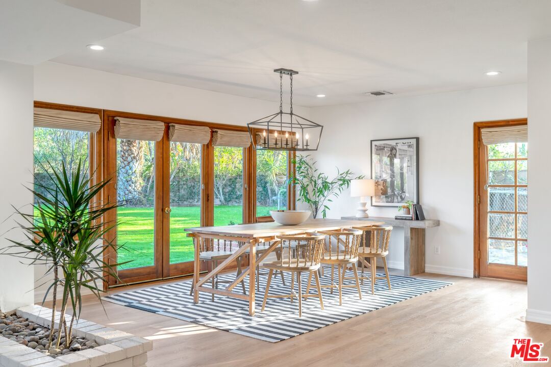 20650 Stagg Street Winnetka, CA 91306 - Photo 18 of 42 a view of a dining room with furniture window and wooden floor