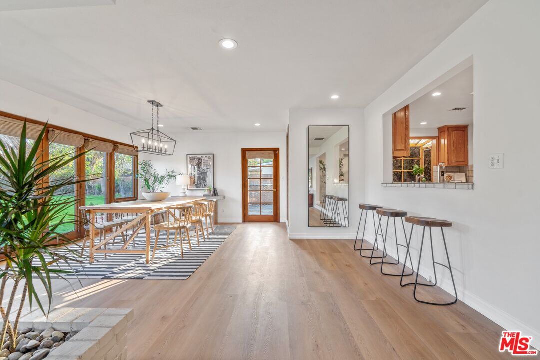 20650 Stagg Street Winnetka, CA 91306 - Photo 20 of 42 a view of a hallway with wooden floor and windows