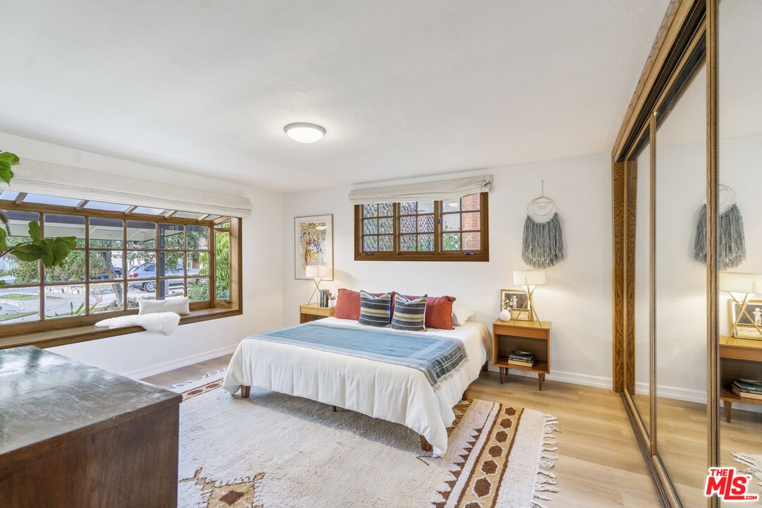 20650 Stagg Street Winnetka, CA 91306 - Photo 23 of 42 a bedroom with a bed and a dresser next to a window