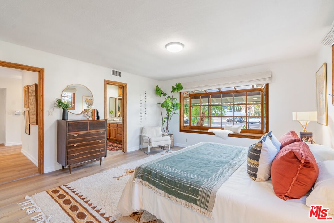 20650 Stagg Street Winnetka, CA 91306 - Photo 24 of 42 a bedroom with furniture and a large window