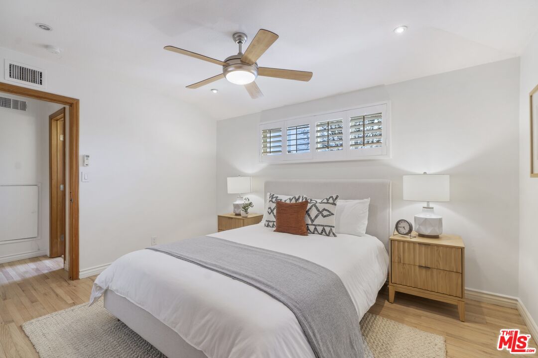 20650 Stagg Street Winnetka, CA 91306 - Photo 30 of 42 a bedroom with a bed and a large mirror