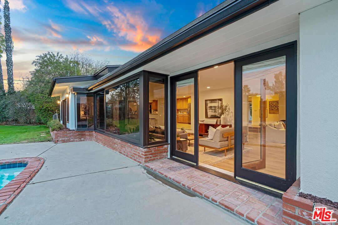 20650 Stagg Street Winnetka, CA 91306 - Photo 33 of 42 a view of a house with porch and wooden floor