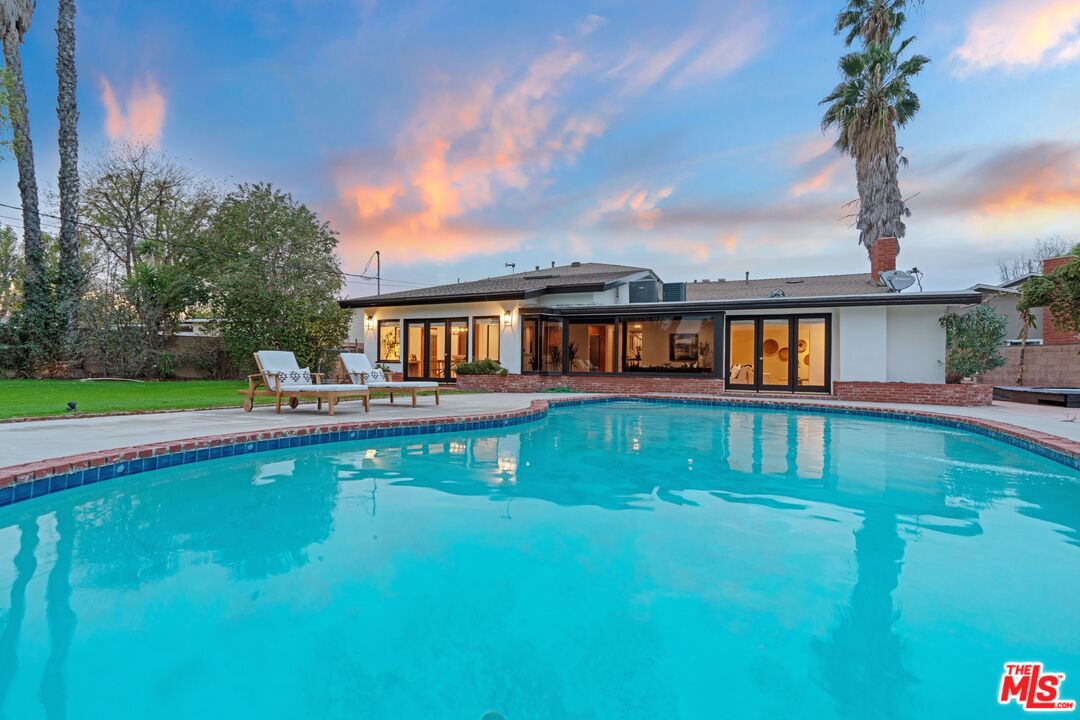20650 Stagg Street Winnetka, CA 91306 - Photo 34 of 42 a front view of a house with swimming pool having outdoor seating