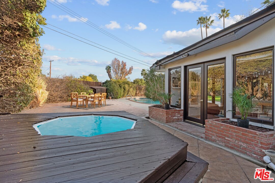 20650 Stagg Street Winnetka, CA 91306 - Photo 36 of 42 a view of outdoor space with swimming pool and furniture