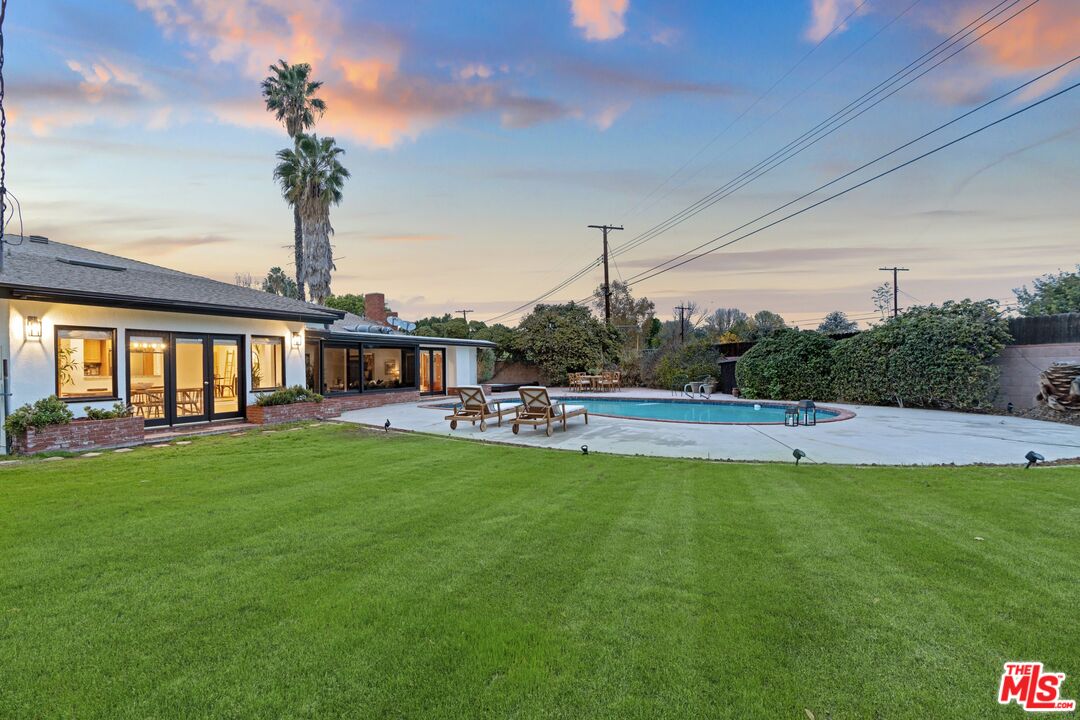 20650 Stagg Street Winnetka, CA 91306 - Photo 39 of 42 a swimming pool with outdoor seating and yard