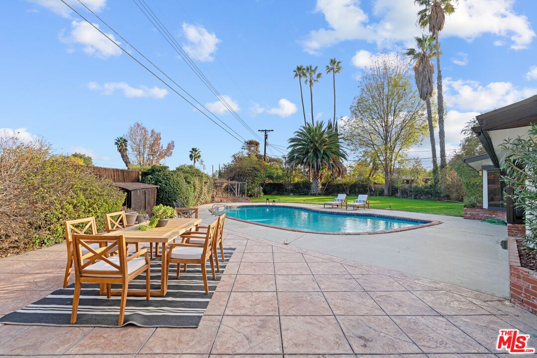 20650 Stagg Street Winnetka, CA 91306 - Photo 40 of 42 a view of a swimming pool with a patio