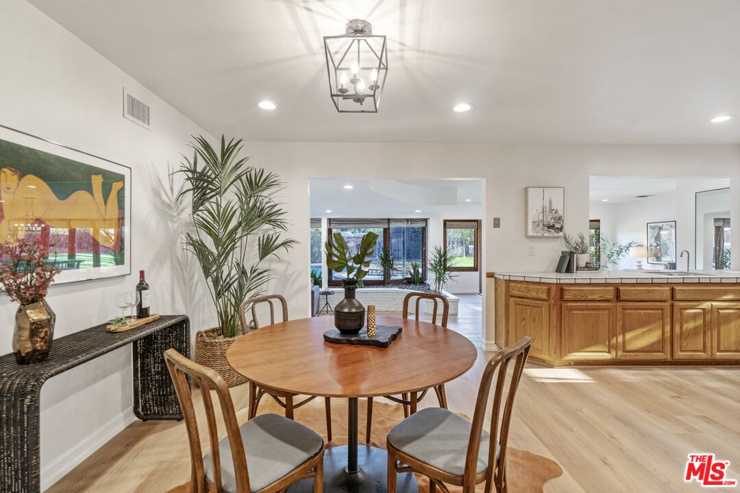 20650 Stagg Street Winnetka, CA 91306 - Photo 6 of 42 a view of a dining room with furniture and window