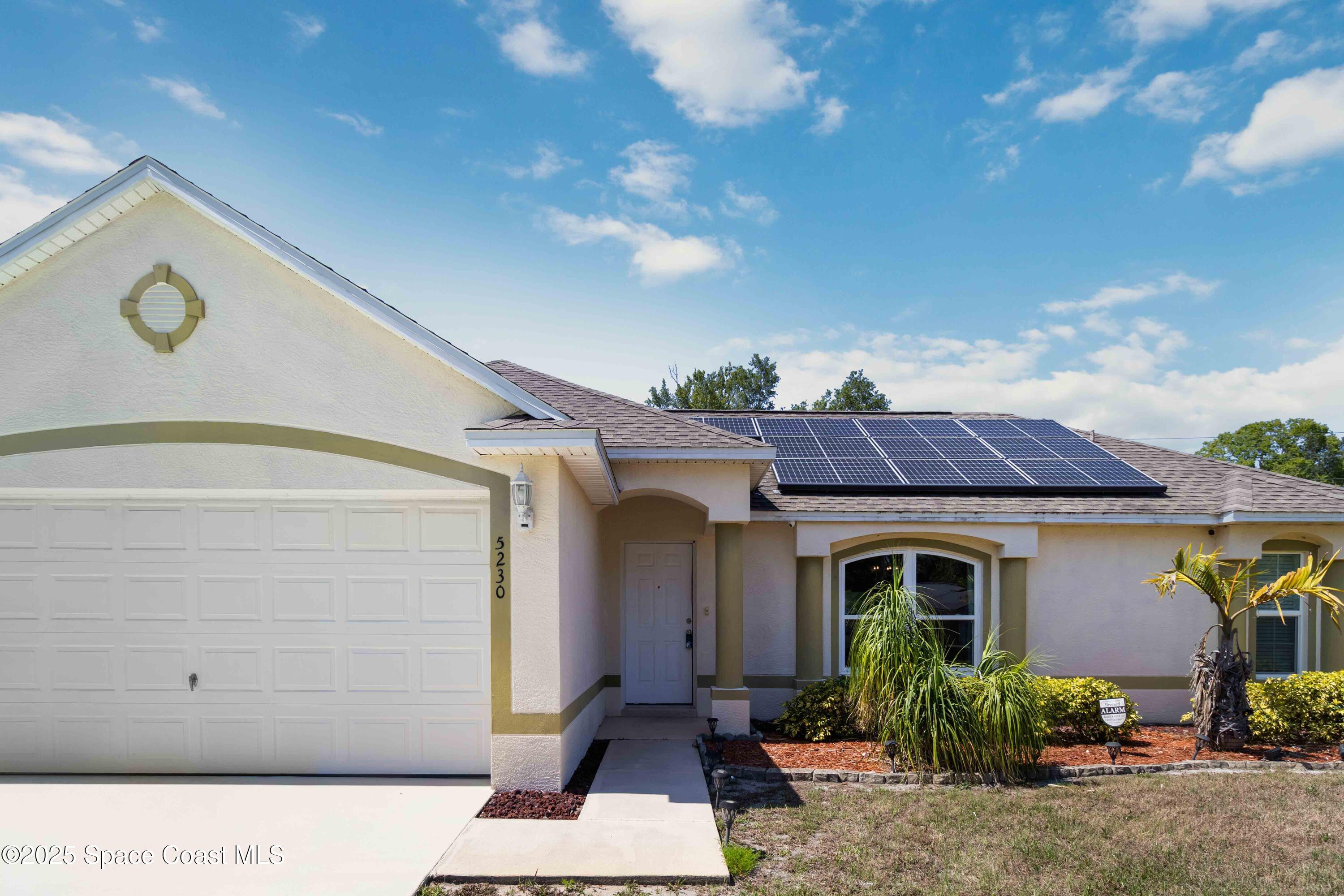 5230 Everett Street Cocoa, FL 32927 - Photo 1 of 29 a front view of a house with garden