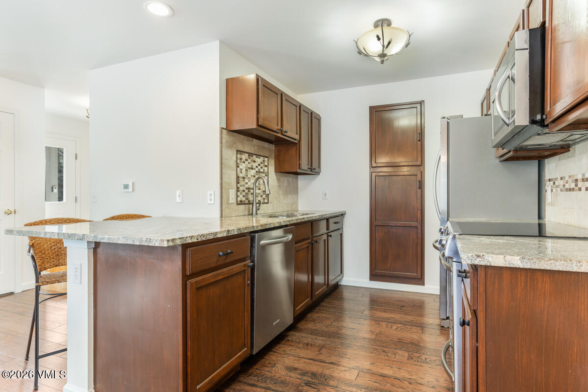 39 Red Tail Drive Edwards, CO 81632 - Photo 9 of 24 a kitchen with stainless steel appliances granite countertop a refrigerator a stove and a sink